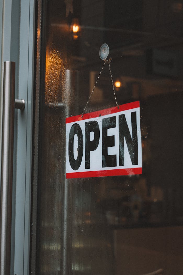 Services-02 Inviting café entrance featuring an open sign on a glass door.