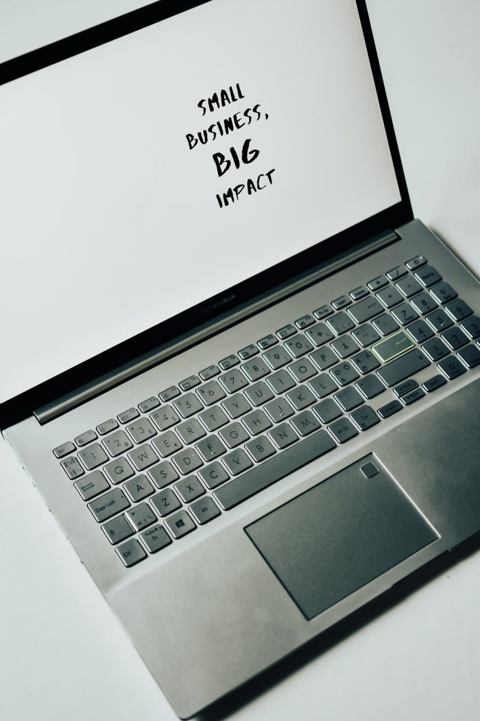 Services-03 A laptop screen with the text 'Small Business, Big Impact,' symbolizing modern entrepreneurship.