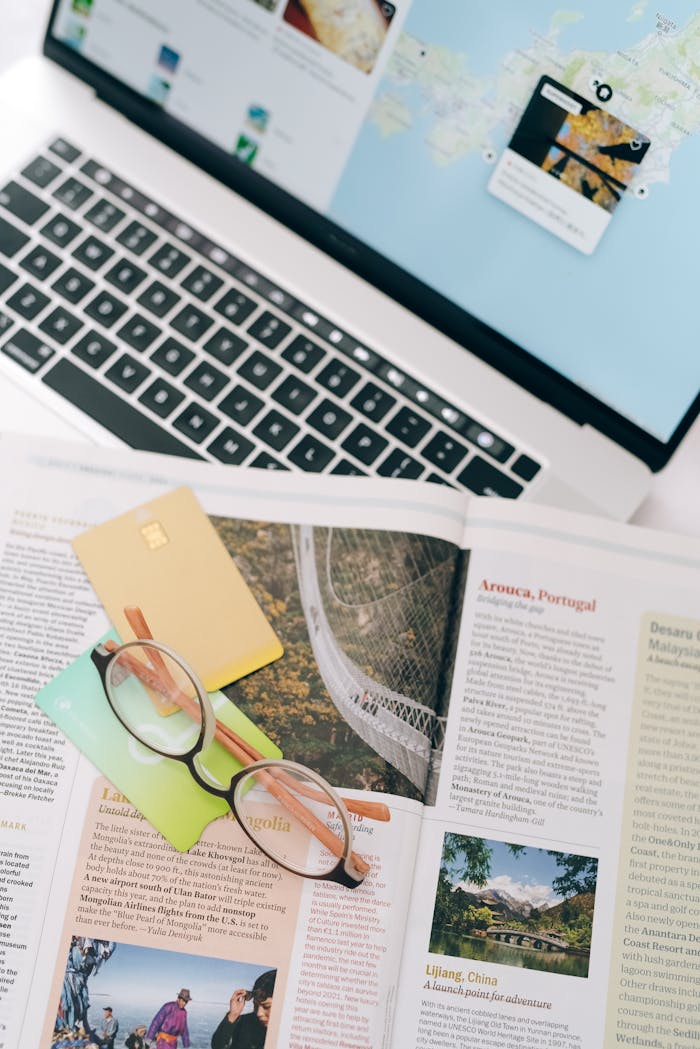 Crafting Captivating Headlines: Your awesome post title goes here Open magazine with eyeglasses and cards next to a laptop, ideal for travel planning themes.